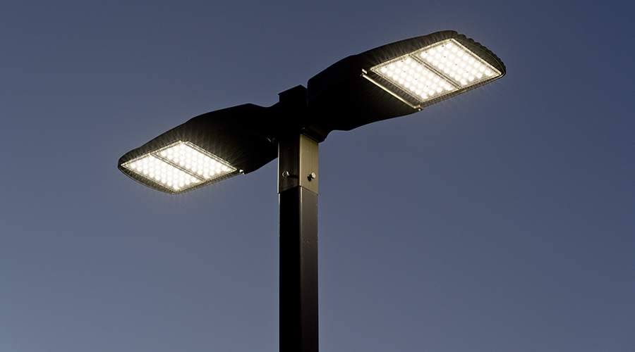 S&W Electric LED commercial parking-lot pole light against evening sky